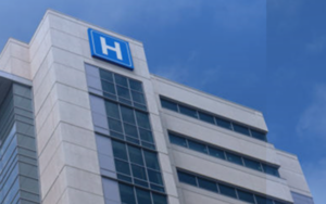 Building with large H sign for hospital. How to prevent hospital failure.